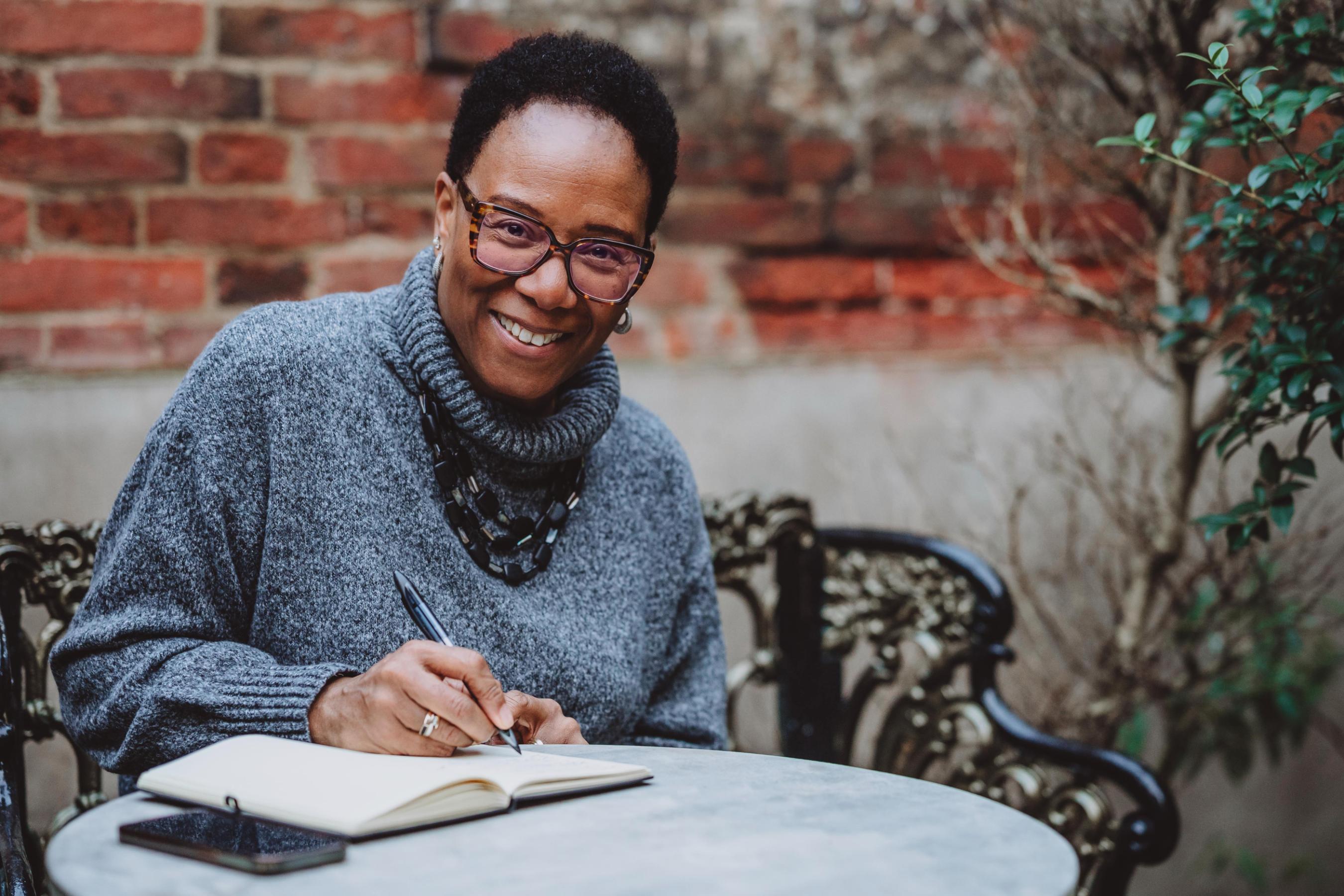 Val Mattinson, luxury wedding planner, writing notes during a consultation, reflecting her calm and supportive planning style