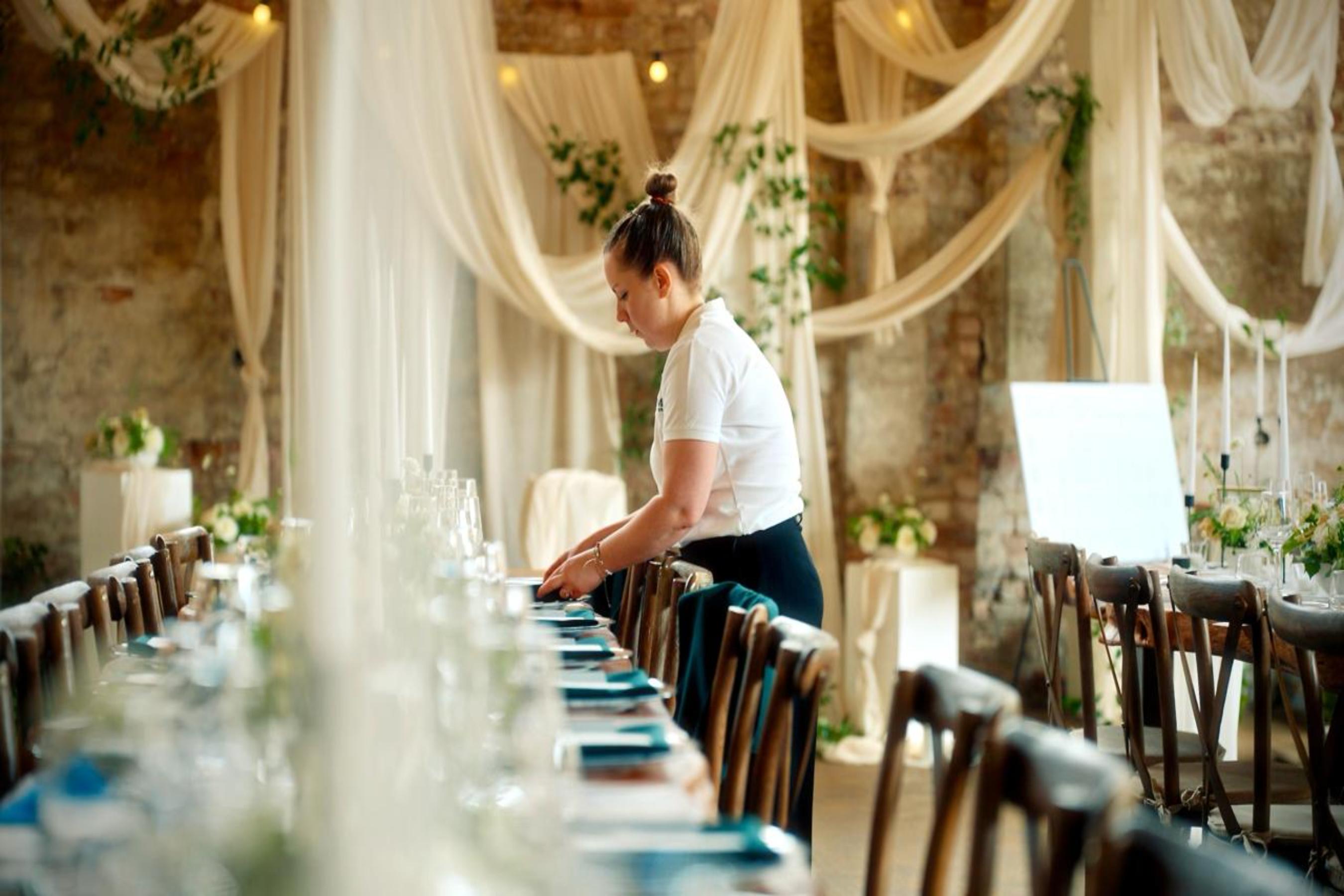 wedding planner setting up elegant reception venue