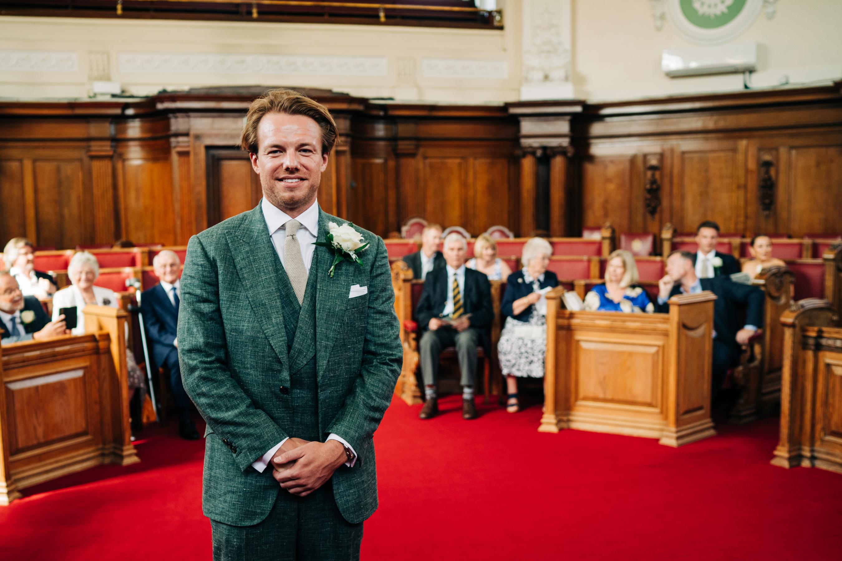 Ben wearing a bespoke green linen three-piece suit created by Cad and the Dandy