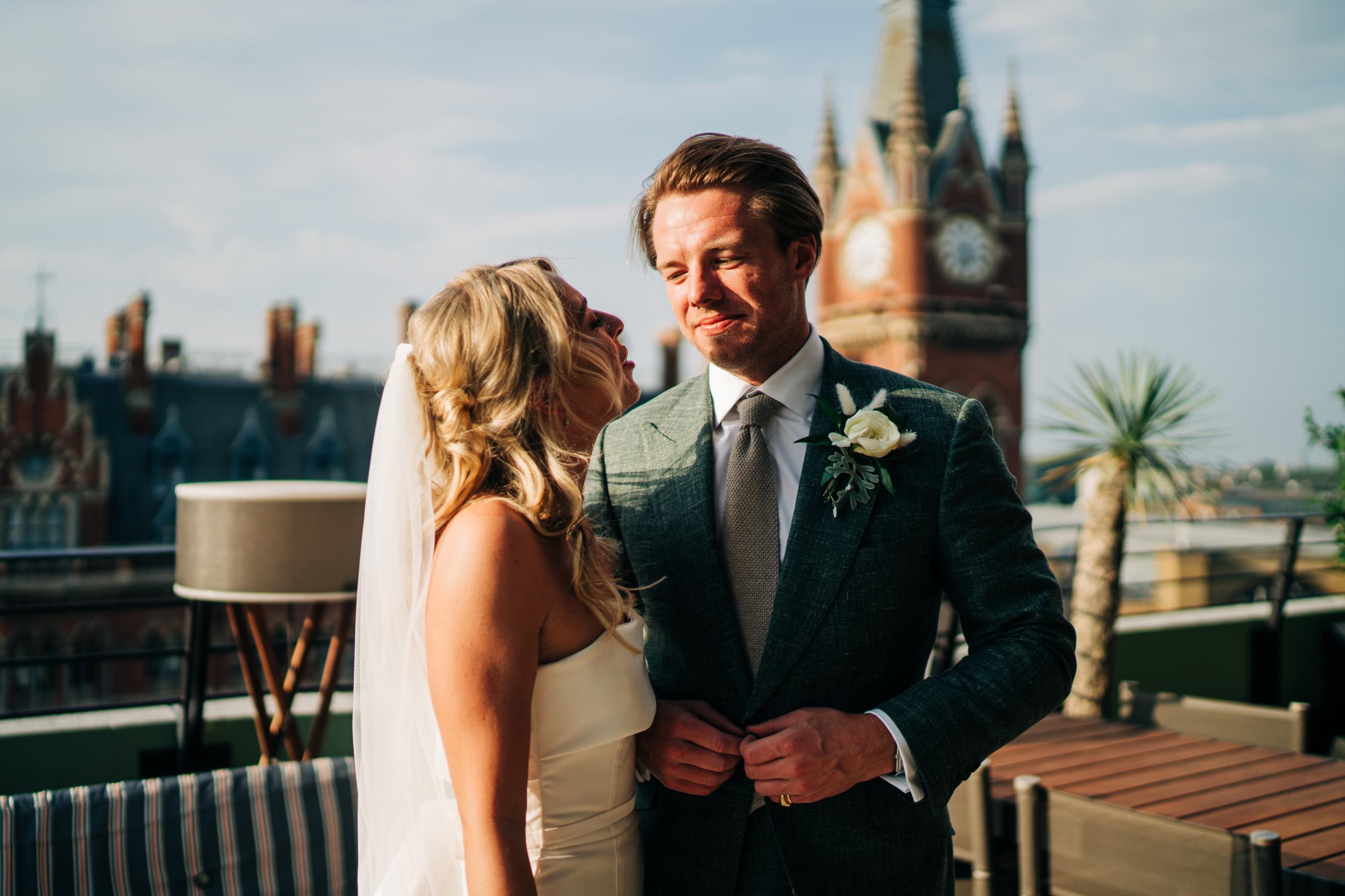 couple celebrating their wedding with a london rooftop view
