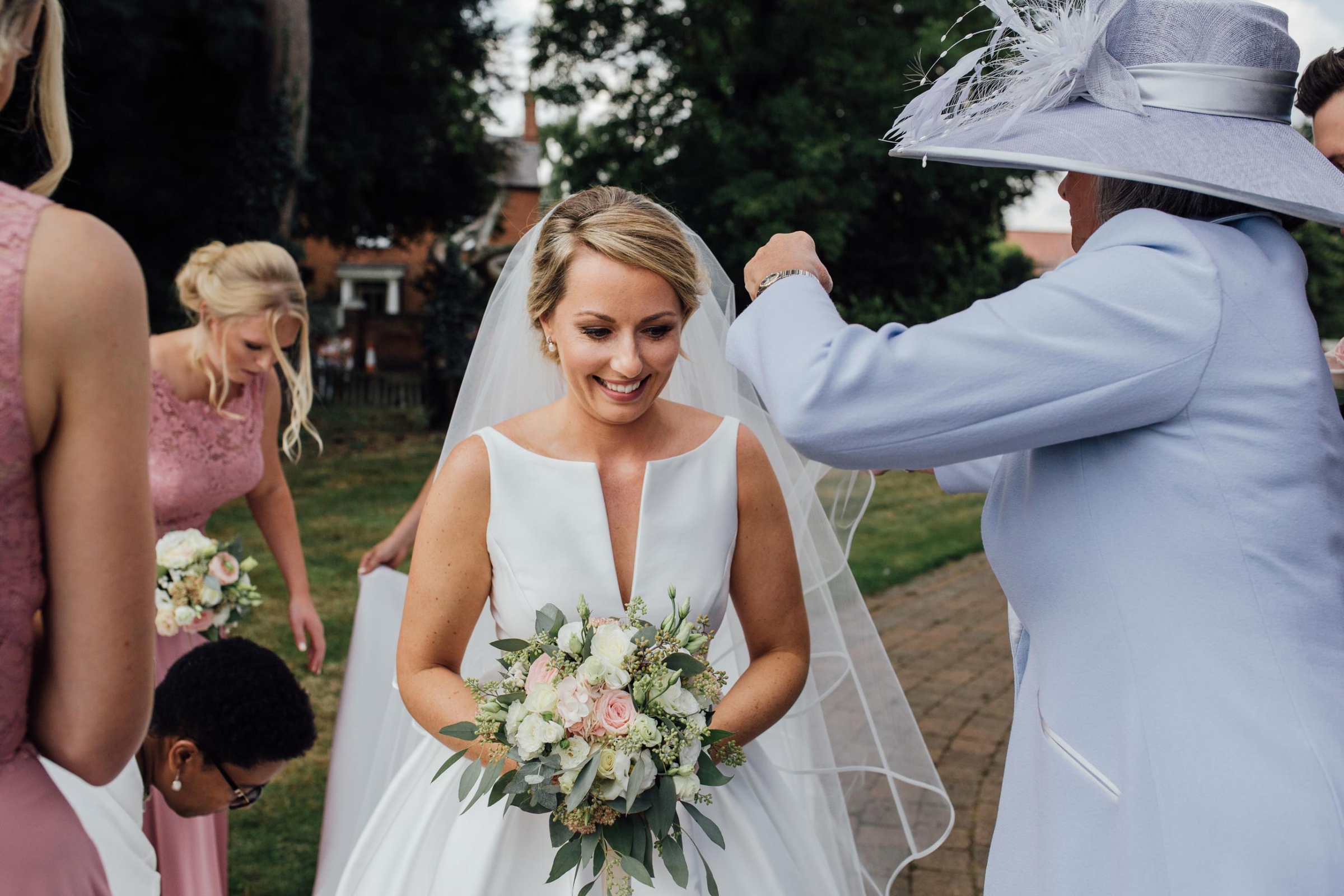 wedding-planner-helping-bride-and-wedding-party-on-the-day